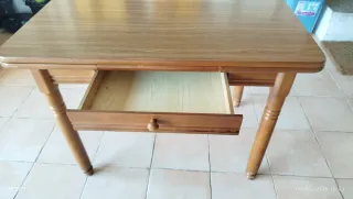 Mesa de cocina extensible de madera con dos alas.