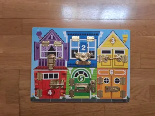 Juguete educativo de madera con puertas y candados