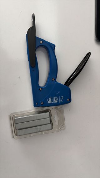 Grapadora azul con grapas