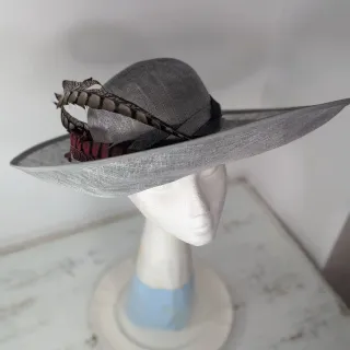 Tocado gris con plumas rosas y marrones