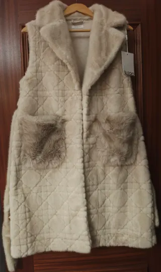 Colete de pêlo fofinho com bolsos e cinto.