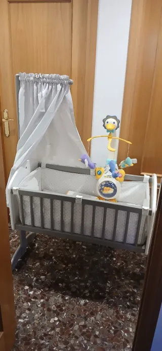 Minicuna con móvil de animales