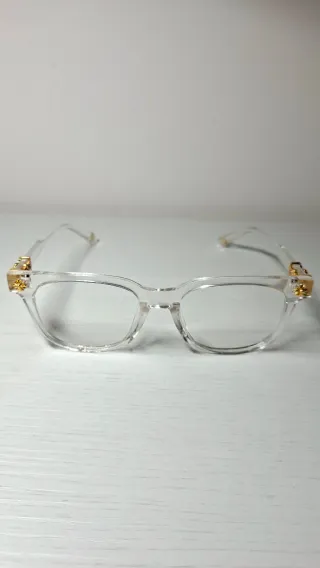 Occhiali trasparenti con dettagli oro