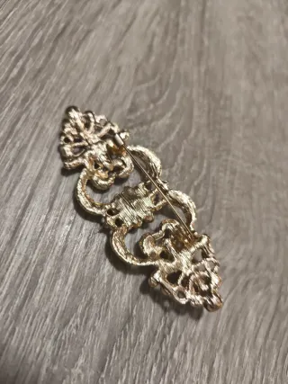 Broche dorado con pedrería