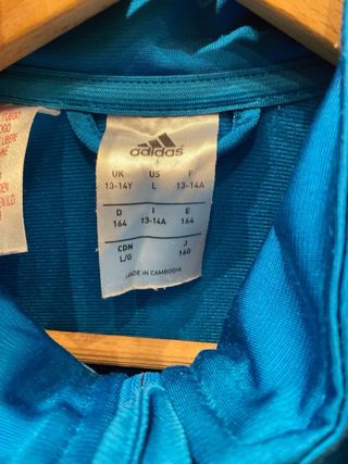 Chaqueta deportiva Adidas azul y negra. 14 años