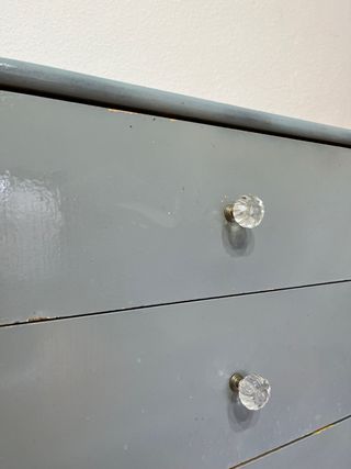 Cajonera de madera gris con tiradores de cristal