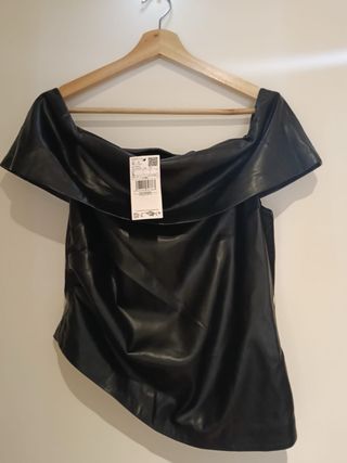 Top efecto piel negro escote bardot asimétrico