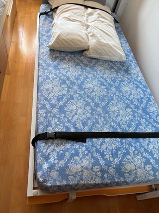 Cama abatible blanca y naranja.
