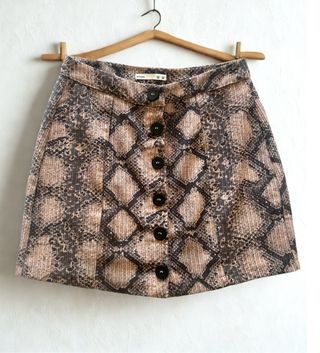 Falda estampada serpiente botones