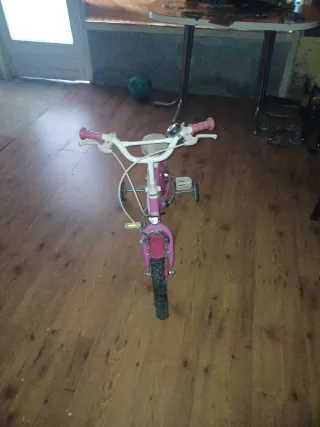 Bicicleta infantil rosa con ruedines