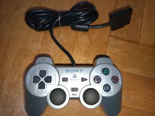 PS2 Oficial Dual Shock 2 Plata Mando
