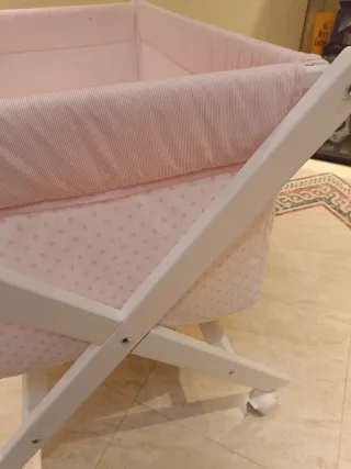 Minicuna con ruedas y vestidura rosa
