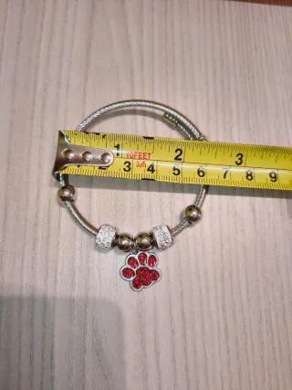 Bracciale 7 charm zampa rossa