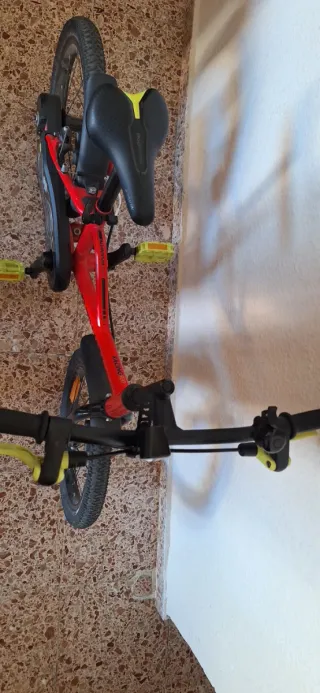 Bicicleta infantil roja con ruedines