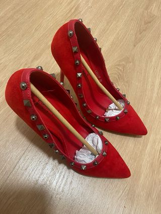 Zapatos de tacón rojos con tachuelas