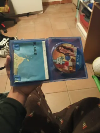 Consola PS4 negra con juegos en disco