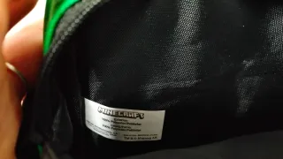 Bandolera verde con cara de Creeper