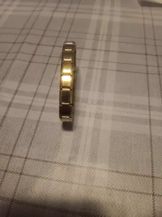 Conjunto Reloj NEXA Oro y Plata y varias joyas.