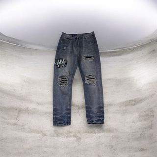 Jeans Amiri con Patch Drago