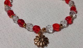 Pulsera con abalorio flor dorada y roja