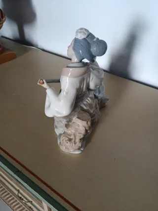 Figura porcelana mujer tocando instrumento