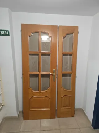 Puerta de salón maciza de madera con cristal