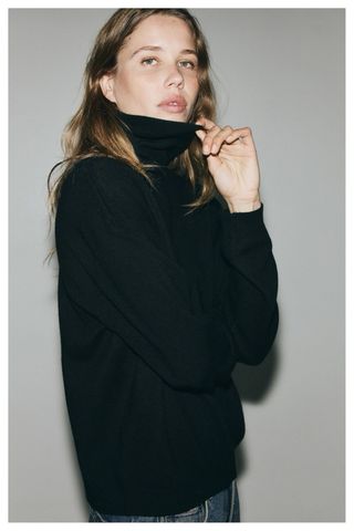 Jersey cuello alto negro adornado botones perlas