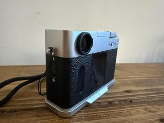 Fotocamera Fujifilm X Half argentata e nera con cinturino