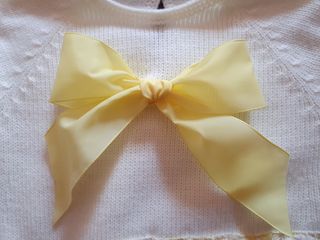 Vestido de bebé blanco con lazo amarillo