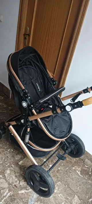 Carro de bebé negro y dorado