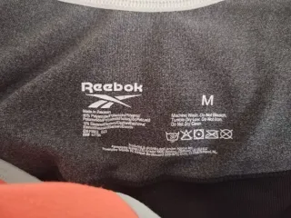 Sujetador deportivo Reebok negro y naranja
