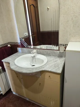 Mueble de baño con lavabo, espejo y griferia