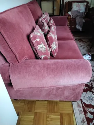 Sofá de tela rojo con cojines