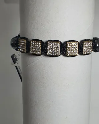 Pulsera negra con detalles dorados y cristales