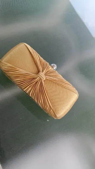 Cartera de mano dorada con pedrería