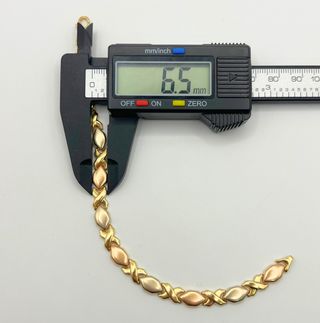 Pulsera fantasía oro combinado 18k. Peso: 10.78 gr