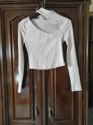 Top beige moderno con escote asimétrico