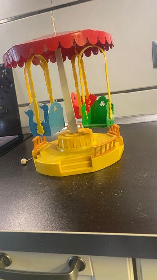 Carrusel infantil con columpios