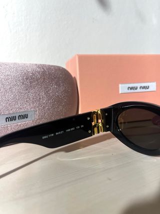 Occhiali da sole Miu Miu donna neri e oro