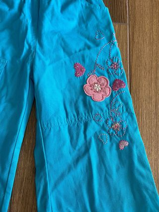 Pantaloni bambina azzurri con fiori fucsia 8 anni