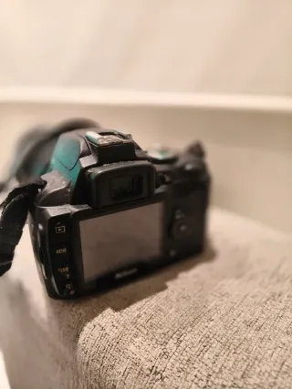 Fotocamera Nikon con obiettivo e caricabatterie