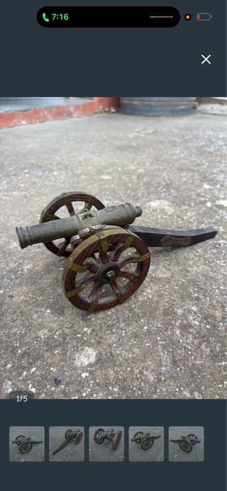 Cañón antiguo de bronce con ruedas