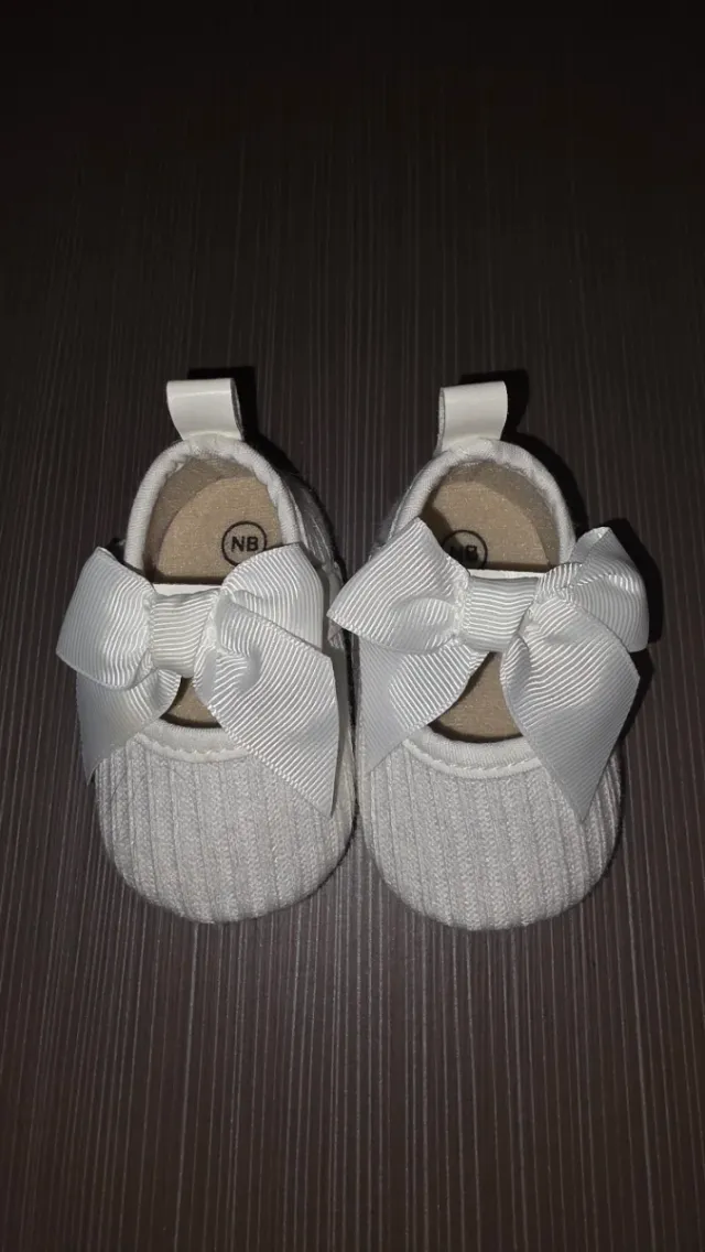 Zapatitos de bebé blancos con lazo