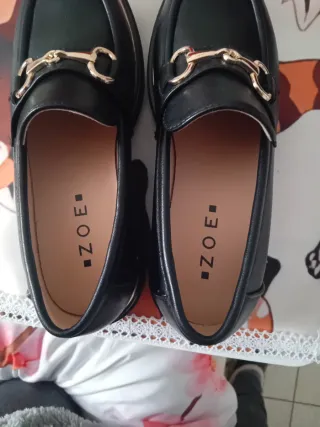 Mocassini Zoe neri con fibbia oro n°37