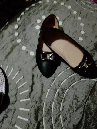 Zapatos negros con detalle dorado