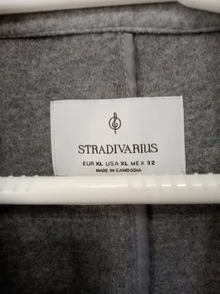 Abrigo gris jaspe botón bolsillos