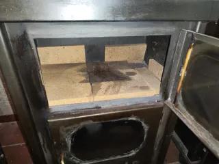 Estufa de hierro negra con detalles dorados