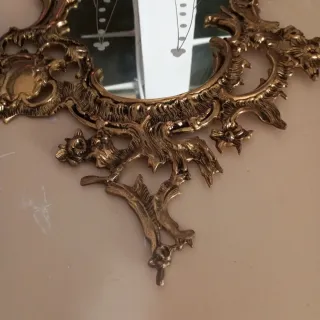 Espejo de bronce antiguo con marco ornamentado