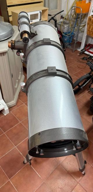 Telescopio plateado con trípode