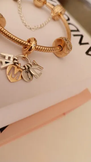 Pulsera Pandora con charms y cadena de seguridad.